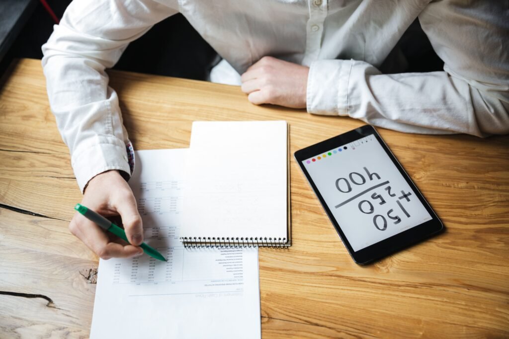 How to calculate aca affordability 2024 using income worksheets, tax documents, and a digital calculator on a desk