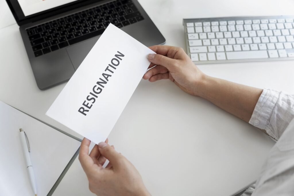 Is ACA registration legitimate concept with person holding a resignation letter at a desk with laptop and keyboard