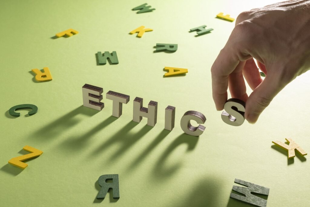 ACA code of ethics concept with wooden letters spelling ethics and a hand arranging letters symbolizing ethical standards and compliance